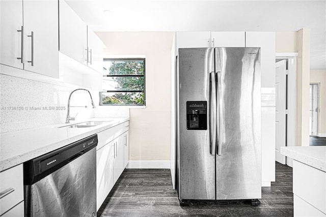 kitchen with white cabinetry, appliances with stainless steel finishes, sink, and dark wood-type flooring