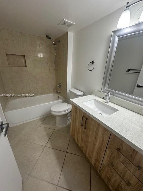 full bathroom featuring bathing tub / shower combination, visible vents, toilet, vanity, and tile patterned floors