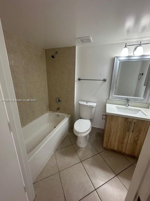 bathroom featuring visible vents, shower / bathing tub combination, toilet, vanity, and tile patterned flooring