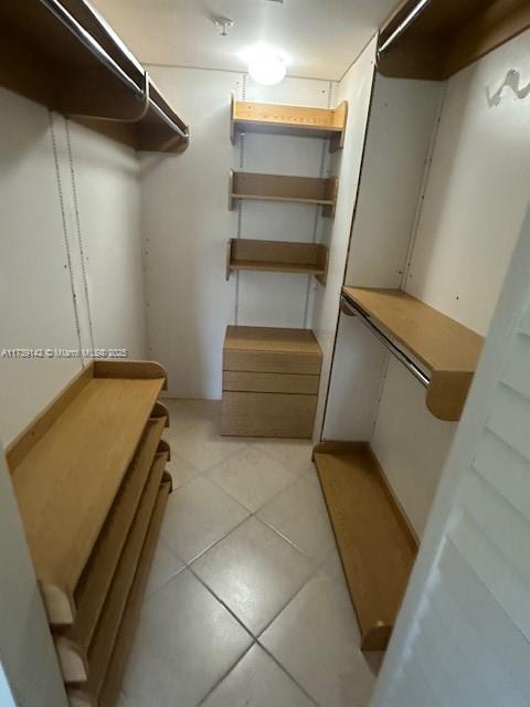 spacious closet with light tile patterned floors