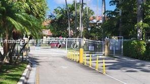 view of street with a gate and a gated entry