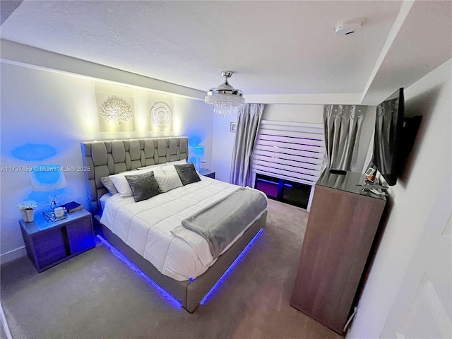 carpeted bedroom featuring an inviting chandelier