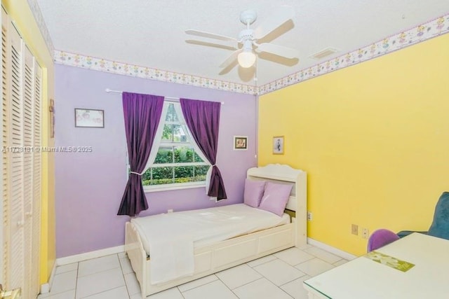 tiled bedroom featuring ceiling fan