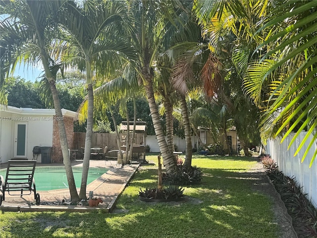 surrounding community featuring a pool, a yard, and a patio area