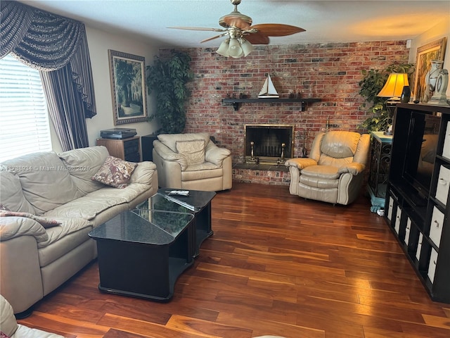 living room featuring a brick fireplace, dark hardwood / wood-style floors, ceiling fan, and brick wall