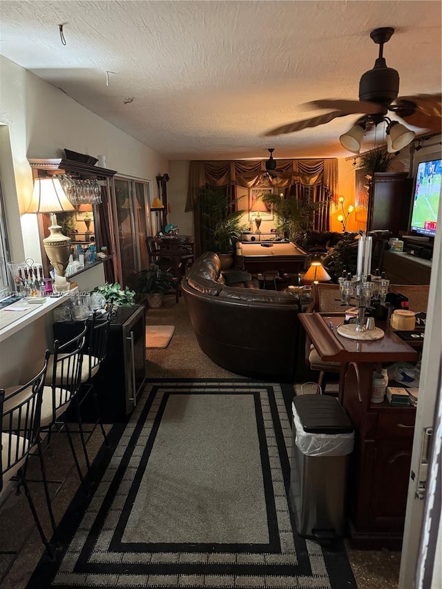 dining area featuring ceiling fan and a textured ceiling