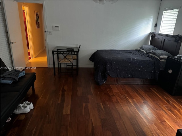 bedroom with dark wood-type flooring