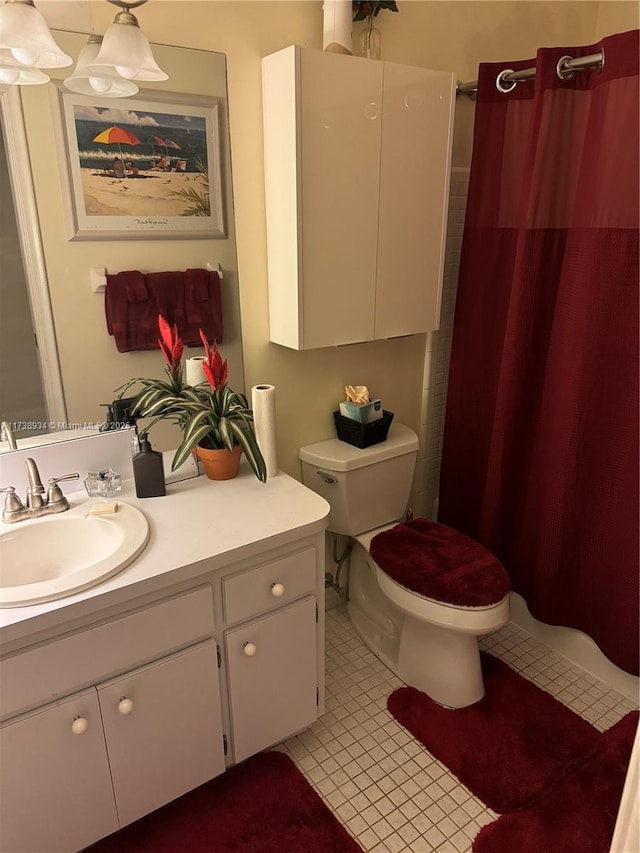 bathroom with tile patterned flooring, vanity, a shower with shower curtain, and toilet