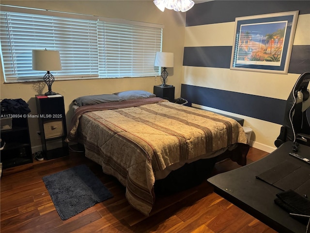 bedroom with dark wood-type flooring