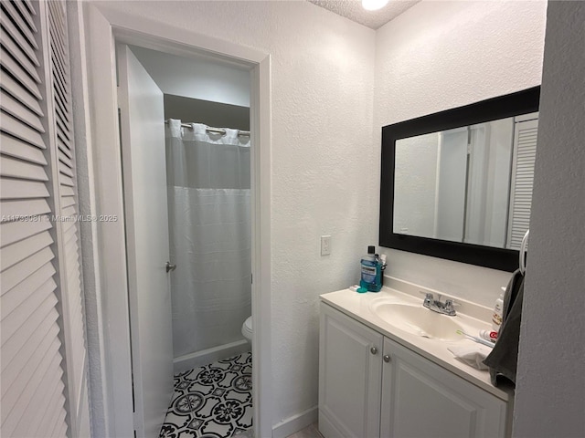 bathroom featuring vanity, toilet, and a shower with shower curtain