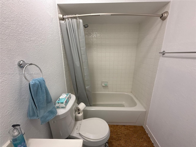 bathroom with shower / bath combo and toilet