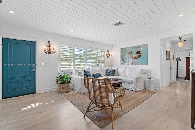 living room featuring light hardwood / wood-style floors and wooden ceiling