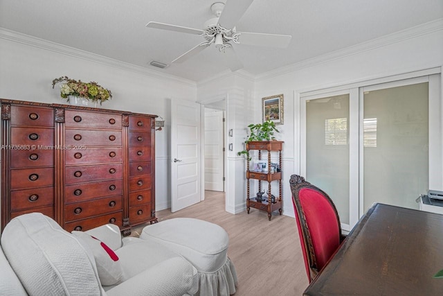 home office featuring crown molding, ceiling fan, and light wood-type flooring