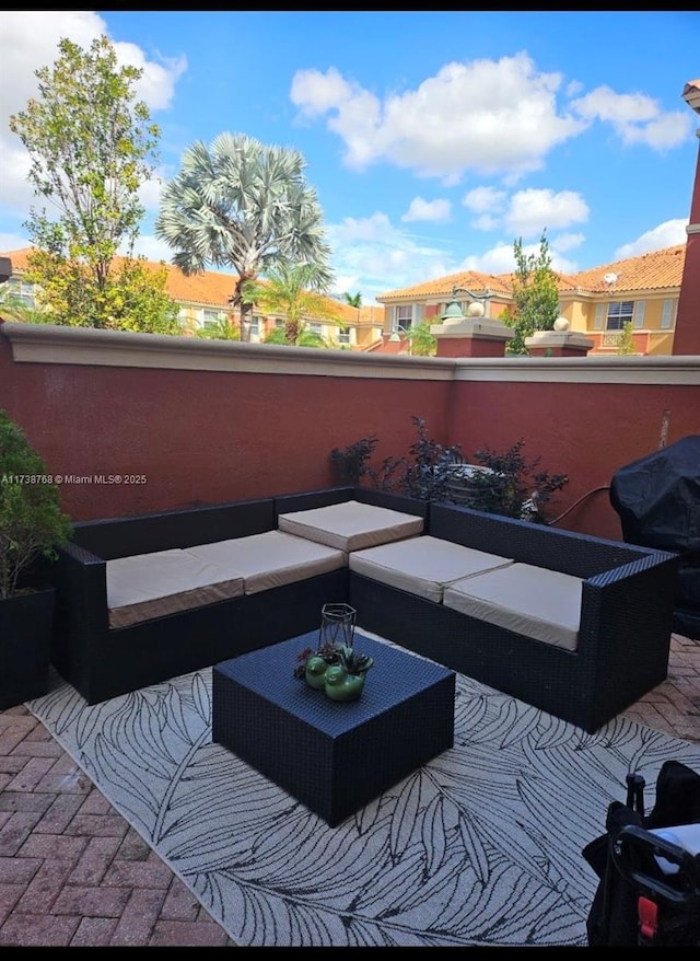 view of patio featuring a grill, an outdoor hangout area, and a balcony