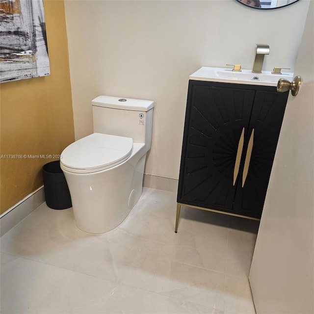 bathroom with vanity, tile patterned flooring, and toilet