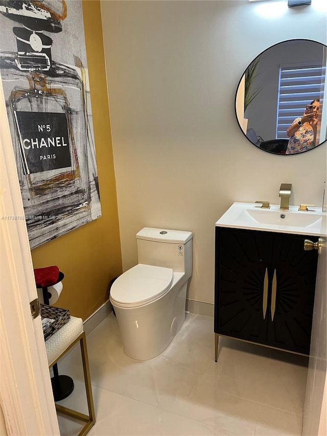 bathroom featuring vanity, toilet, and tile patterned flooring