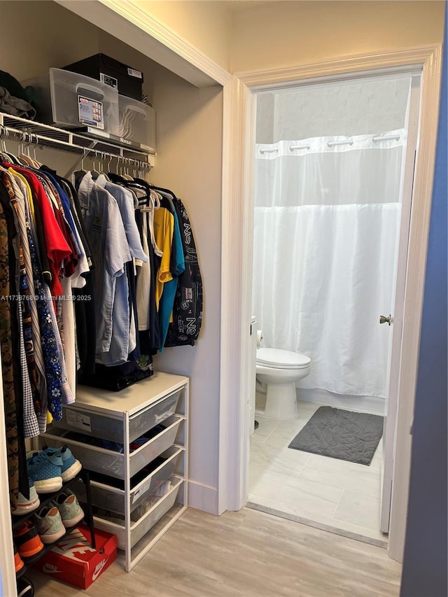 bathroom featuring hardwood / wood-style floors and toilet