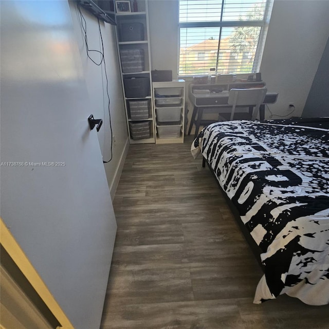 bedroom with dark hardwood / wood-style flooring