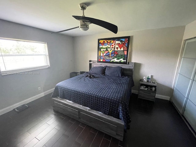 bedroom with dark hardwood / wood-style floors and ceiling fan