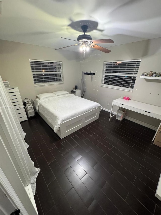 bedroom with ceiling fan and dark hardwood / wood-style flooring