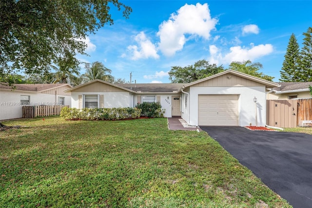 single story home featuring a garage, driveway, fence, and a front lawn