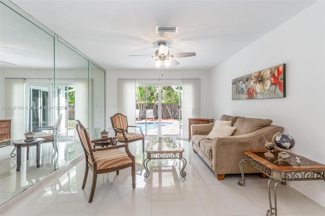 living room featuring light tile patterned flooring and ceiling fan