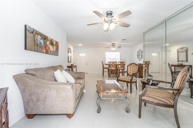 tiled living room featuring ceiling fan