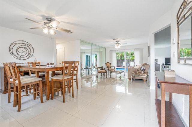 dining area featuring light tile patterned floors and ceiling fan