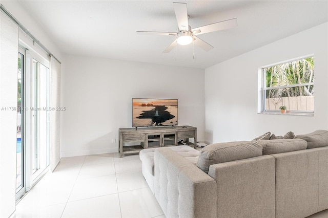 living room with ceiling fan, a healthy amount of sunlight, and light tile patterned floors