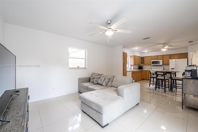 tiled living room featuring ceiling fan