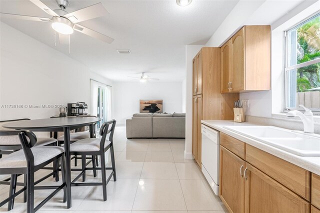 kitchen featuring sink, light tile patterned floors, dishwasher, and ceiling fan