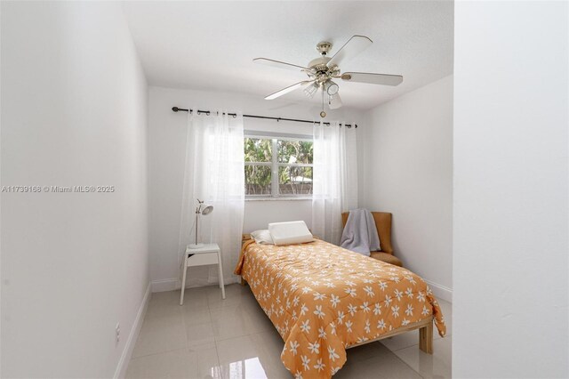 bedroom with light tile patterned floors, baseboards, and ceiling fan