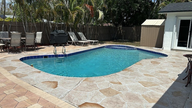 view of swimming pool with outdoor dining space, fence, a fenced in pool, and a patio