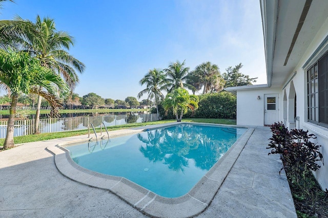 view of pool featuring a patio and a water view