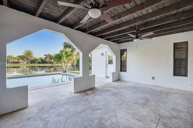 view of patio featuring a fenced in pool, ceiling fan, and a water view