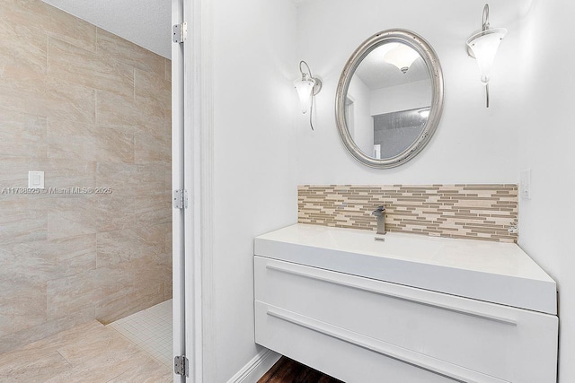 bathroom featuring tasteful backsplash and vanity