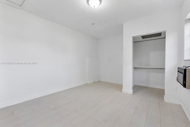 unfurnished bedroom with light hardwood / wood-style flooring, a closet, and a textured ceiling