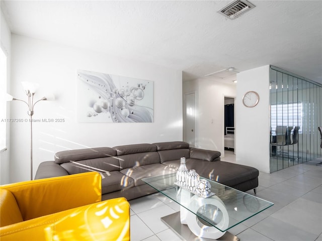 living room with light tile patterned floors and a textured ceiling