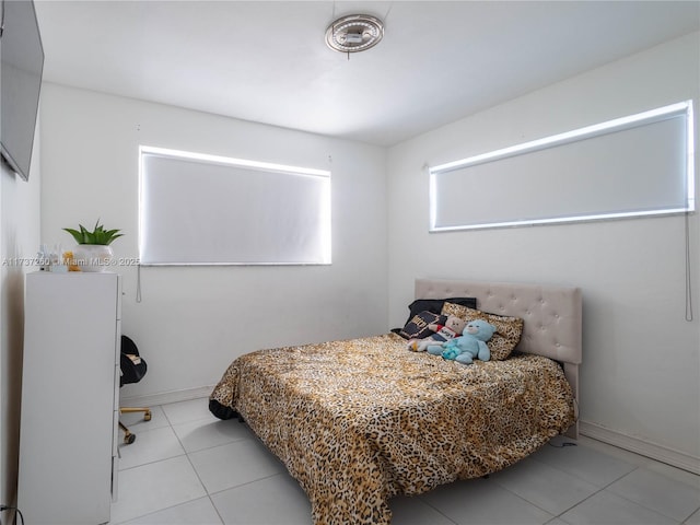 bedroom with light tile patterned floors