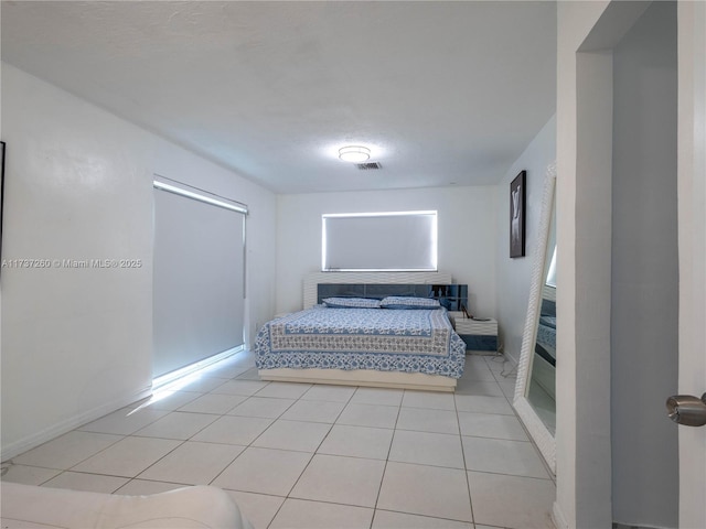 bedroom with light tile patterned flooring