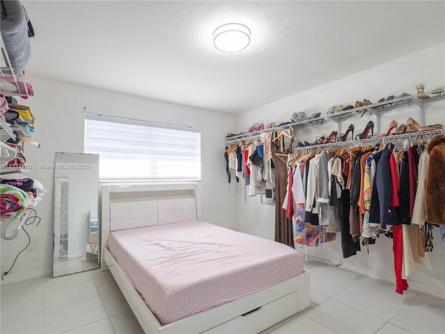 tiled bedroom with a closet