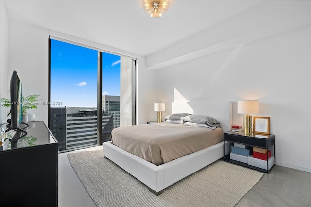 bedroom with floor to ceiling windows and access to outside