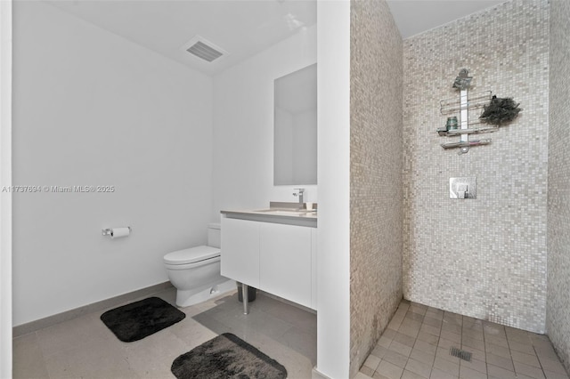 bathroom featuring tile patterned floors, vanity, and toilet