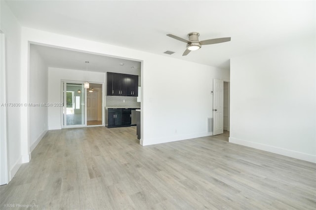 unfurnished living room with visible vents, baseboards, and light wood-style floors