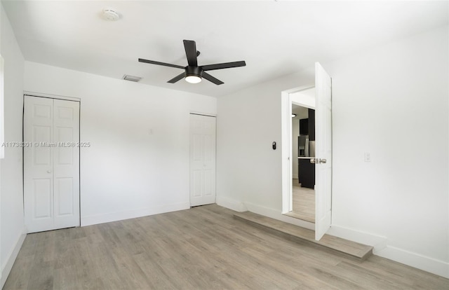 unfurnished bedroom featuring ceiling fan and light hardwood / wood-style flooring