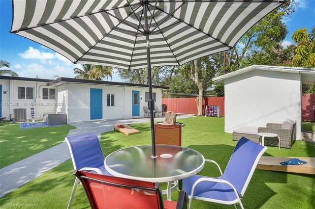 view of yard featuring a storage shed, outdoor lounge area, and a patio