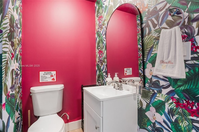 bathroom featuring vanity and toilet