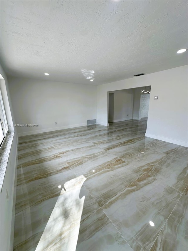 spare room featuring a textured ceiling