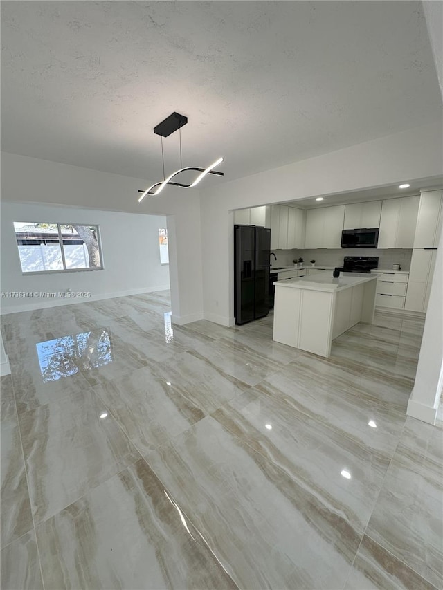 kitchen with white cabinetry, decorative light fixtures, a center island, a textured ceiling, and black appliances