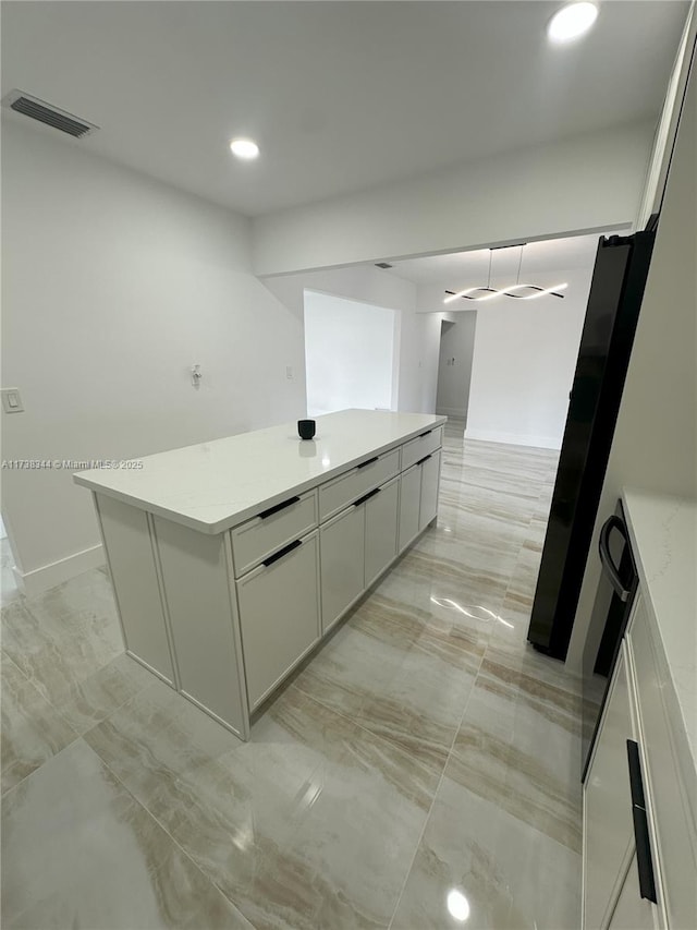 kitchen with a center island and white cabinets